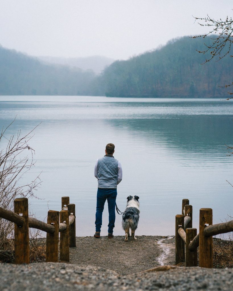 Man-with-dog-at-lake