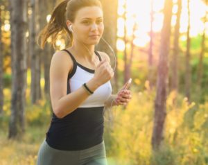 Woman running through the woods