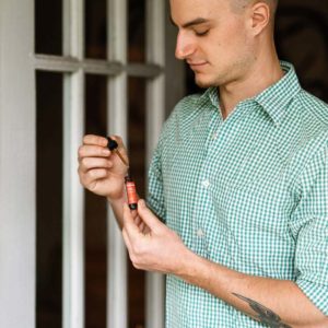 Man holding Tanasi CBD Tincture