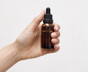 woman holding cbd oil tincture