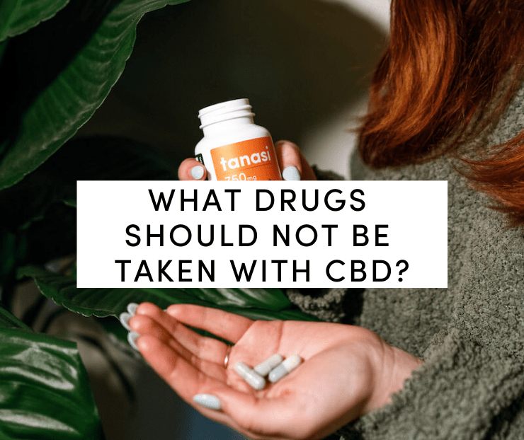 Woman in green shirt holding Tanasi CBD capsules