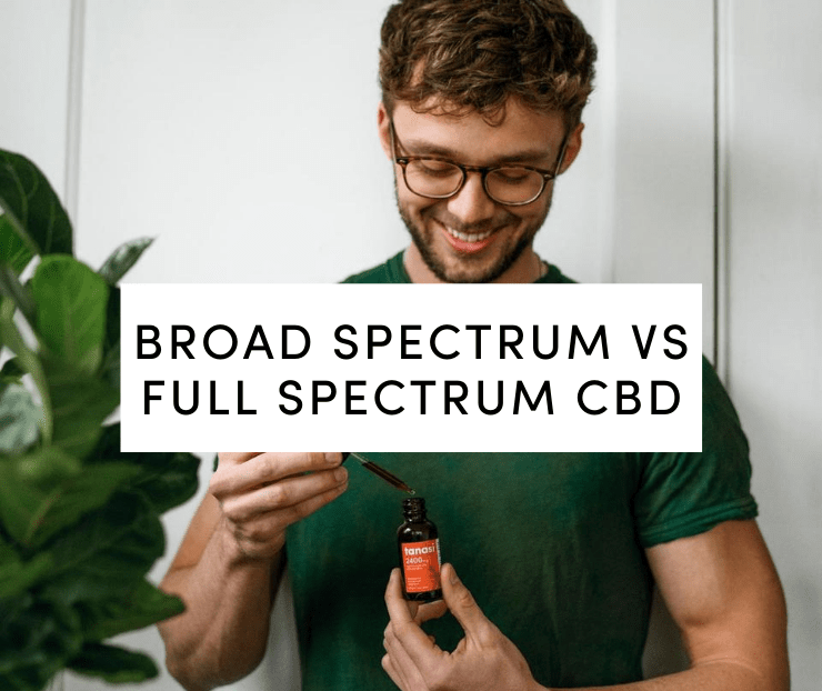 Man in green shirt holding Tanasi Full Spectrum tincture