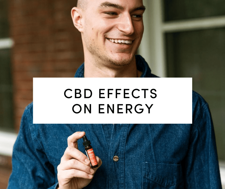Man in blue shirt holding CBD tincture