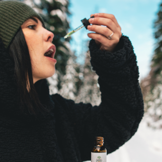 How Often Can You Take CBD Oil - woman about to take CBD sublingually